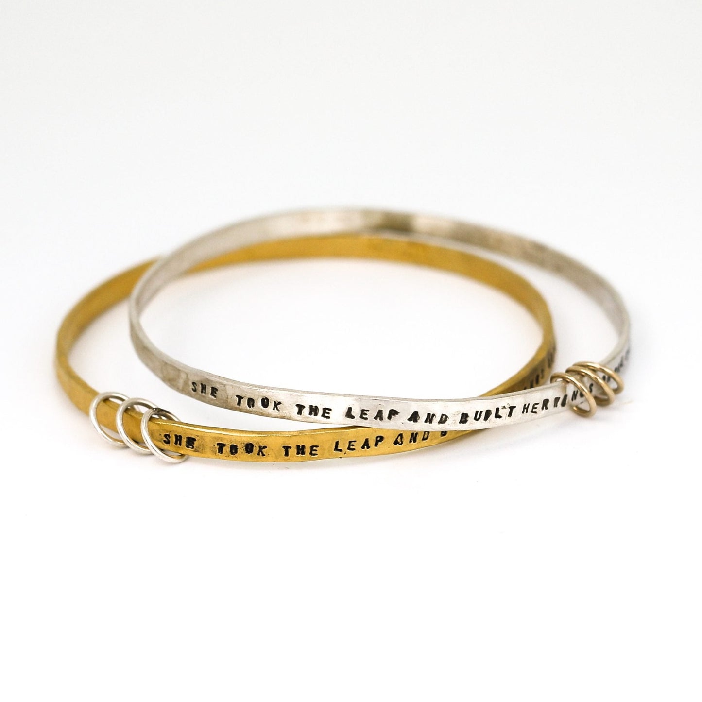 "She took the leap and built her wings on the way down" - three ring bangle
